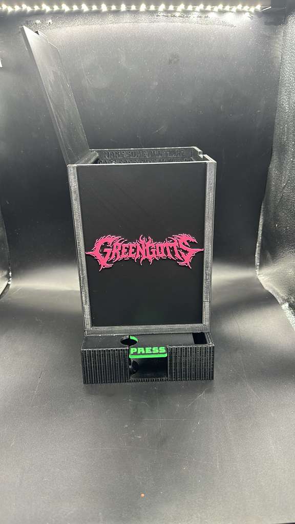 Black small tube dispenser with press button on top